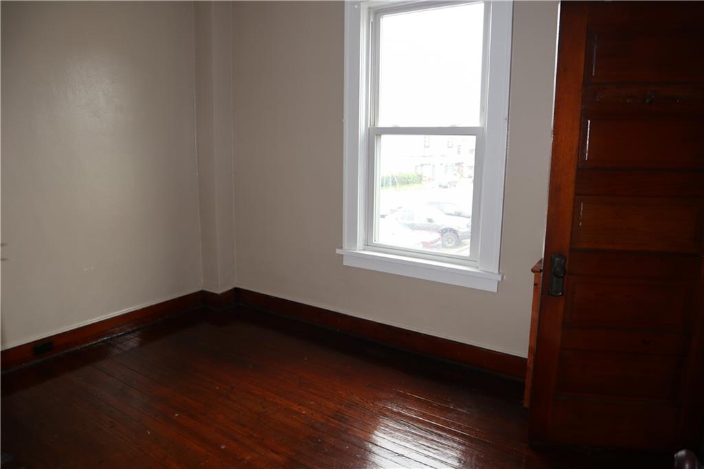 426 Broad Avenue, Unit 2 Belle Vernon, PA 15012 - Photo 11 of 13 a view of an empty room with wooden floor and a window