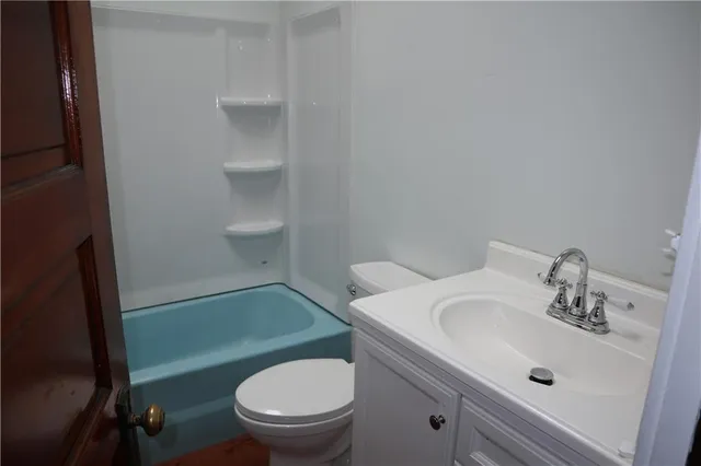 a bathroom with a sink toilet and a mirror