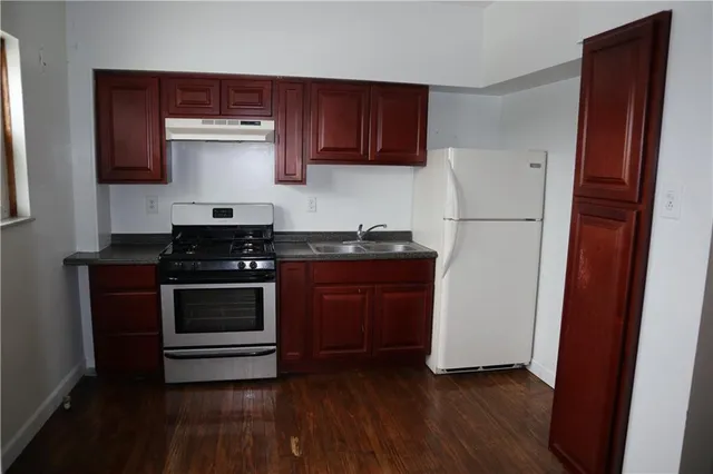 a kitchen with a refrigerator and a stove