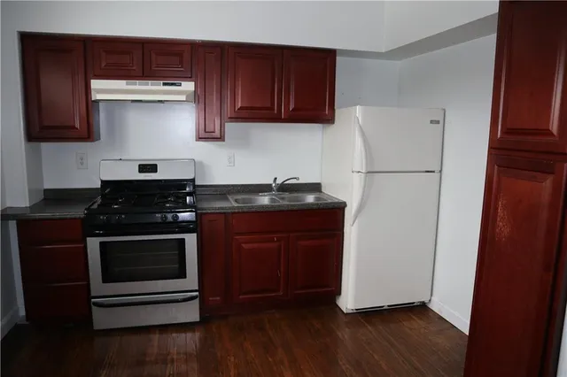 a kitchen with a stove and white cabinets