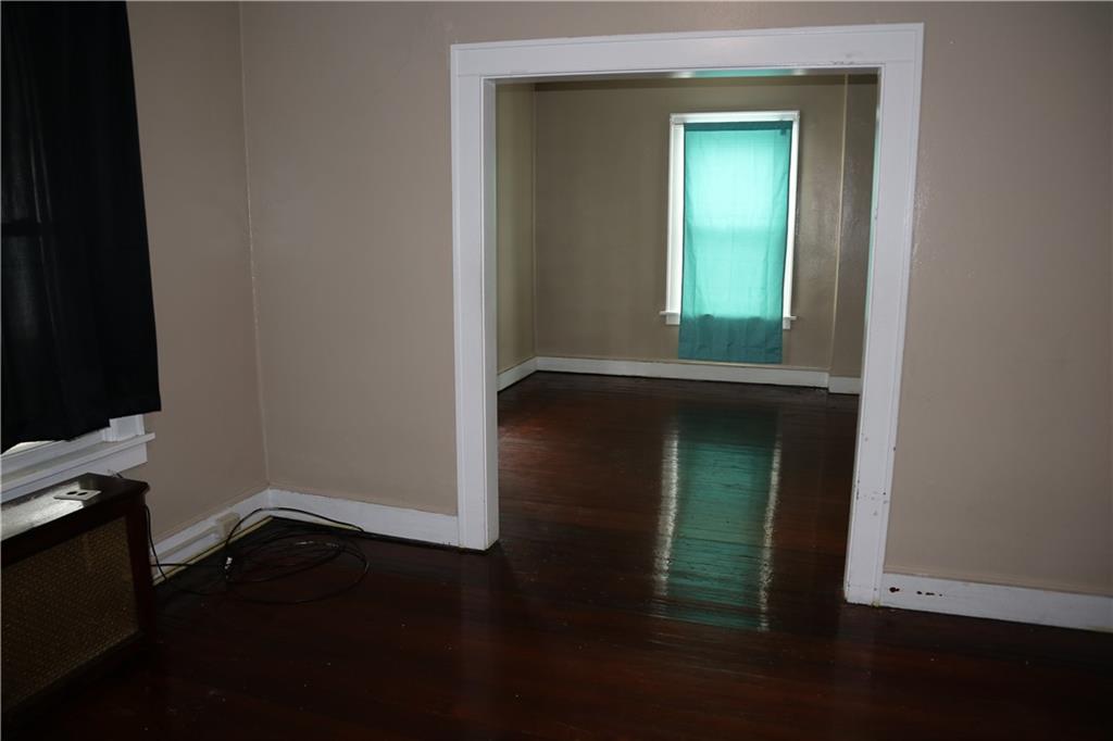 426 Broad Avenue, Unit 2 Belle Vernon, PA 15012 - Photo 8 of 13 an empty room with wooden floor a glass door and a window