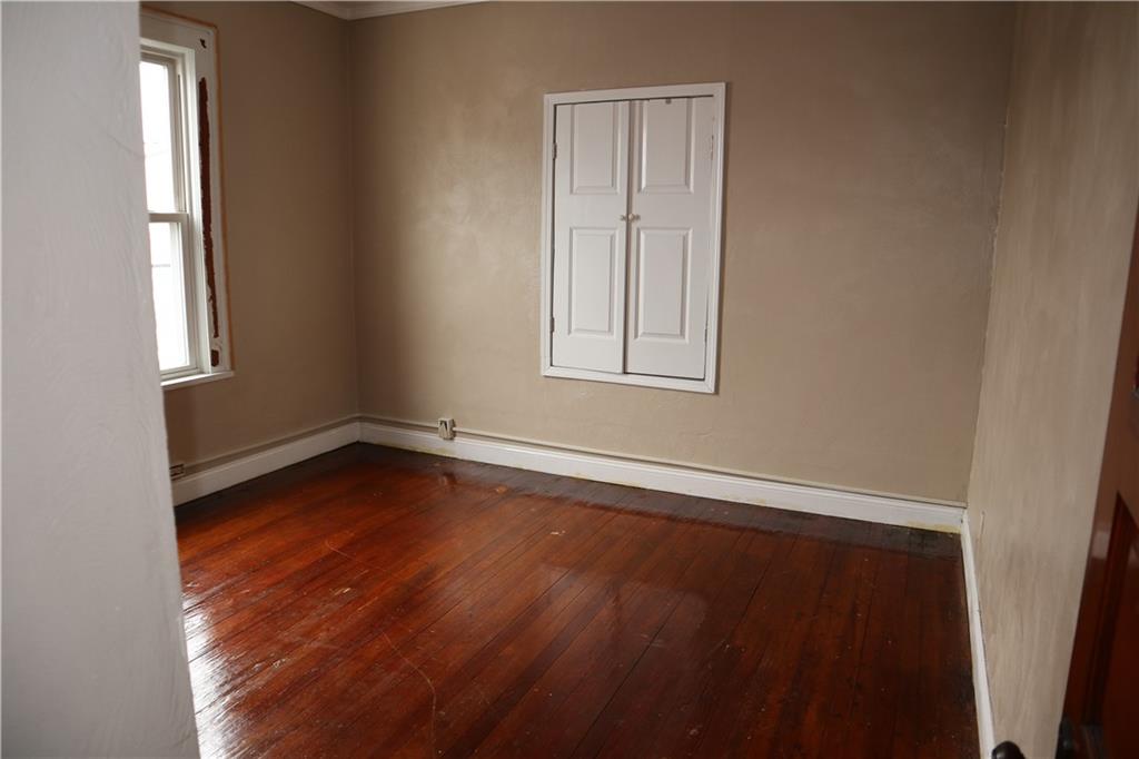 426 Broad Avenue, Unit 2 Belle Vernon, PA 15012 - Photo 9 of 13 an empty room with wooden floor and windows