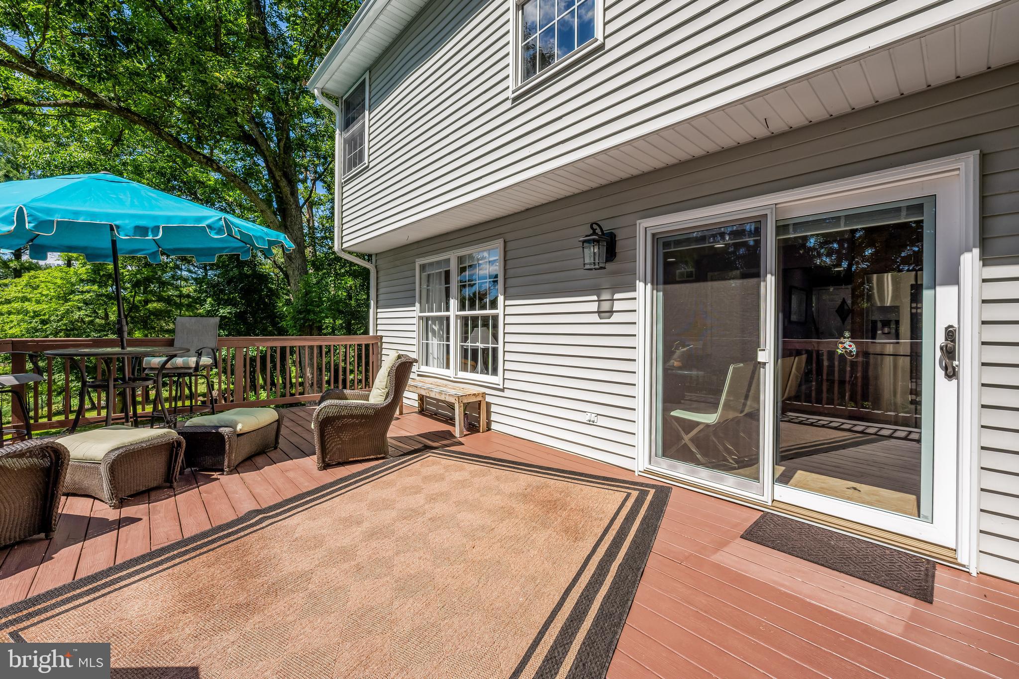 5026 Mt Carmel Road Hampstead, MD 21074 - Photo 23 of 57 a roof deck with table and chairs under an umbrella