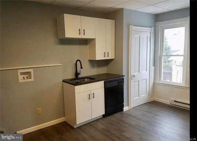 a kitchen with granite countertop a sink and a stove top oven