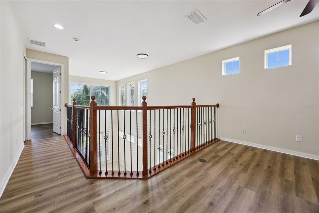 551 Terrace Spring Drive Orlando, FL 32828 - Photo 22 of 41 a view of a hallway with wooden floor