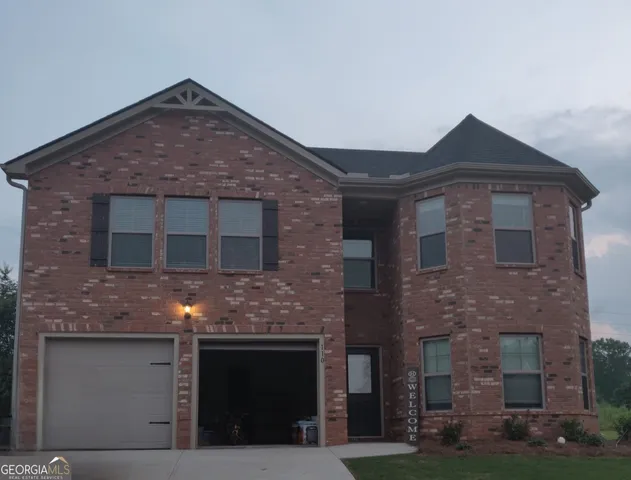 a front view of a house with yard