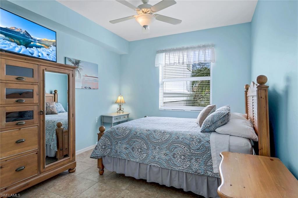 460 Launch Circle, Unit 301 Naples, FL 34108 - Photo 11 of 28 a bedroom with a bed and window