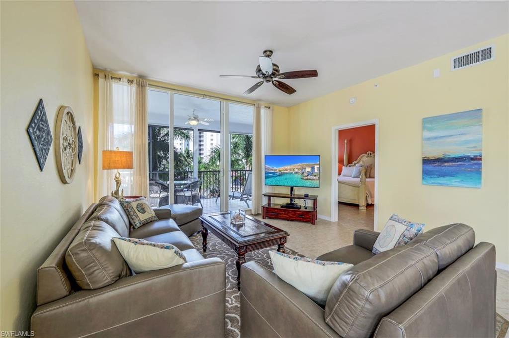 460 Launch Circle, Unit 301 Naples, FL 34108 - Photo 2 of 28 a living room with furniture and a large window