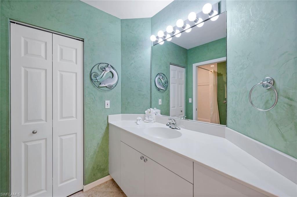 460 Launch Circle, Unit 301 Naples, FL 34108 - Photo 10 of 28 a bathroom with a sink and a mirror