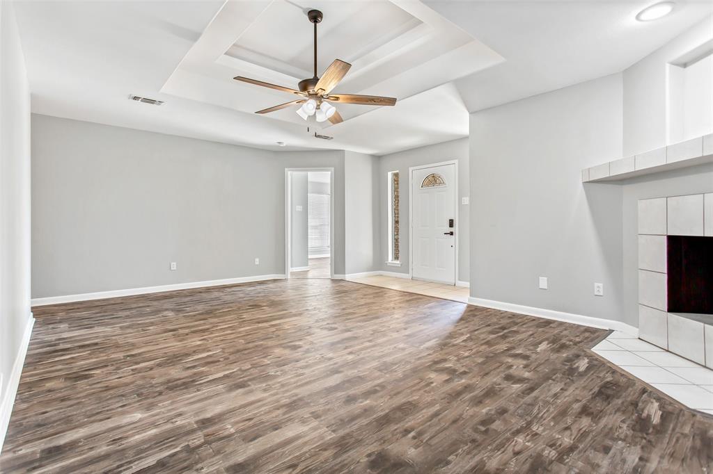 712 Billups Street Van Alstyne, TX 75495 - Photo 8 of 38 a view of an empty room with a fireplace and a window