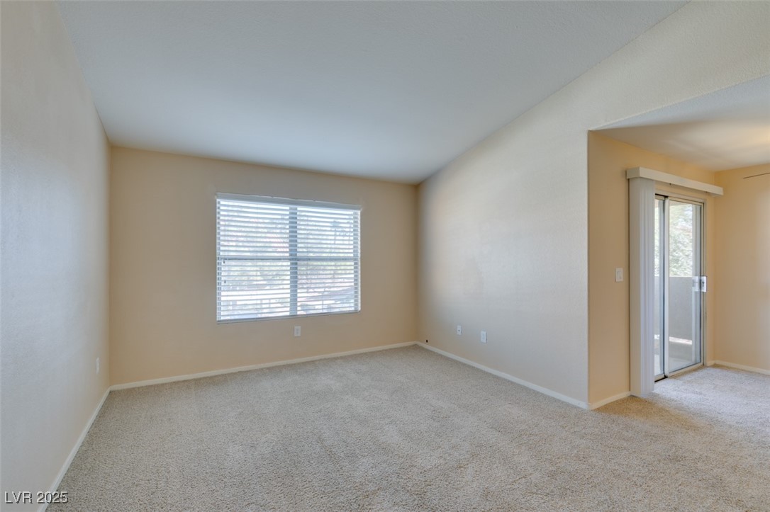 2300 East Silverado Ranch Boulevard, Unit 2190 Las Vegas, NV 89123 - Photo 11 of 41 Empty room with light colored carpet and baseboards