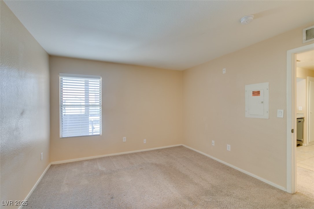 2300 East Silverado Ranch Boulevard, Unit 2190 Las Vegas, NV 89123 - Photo 31 of 41 Unfurnished room featuring light carpet and electric panel