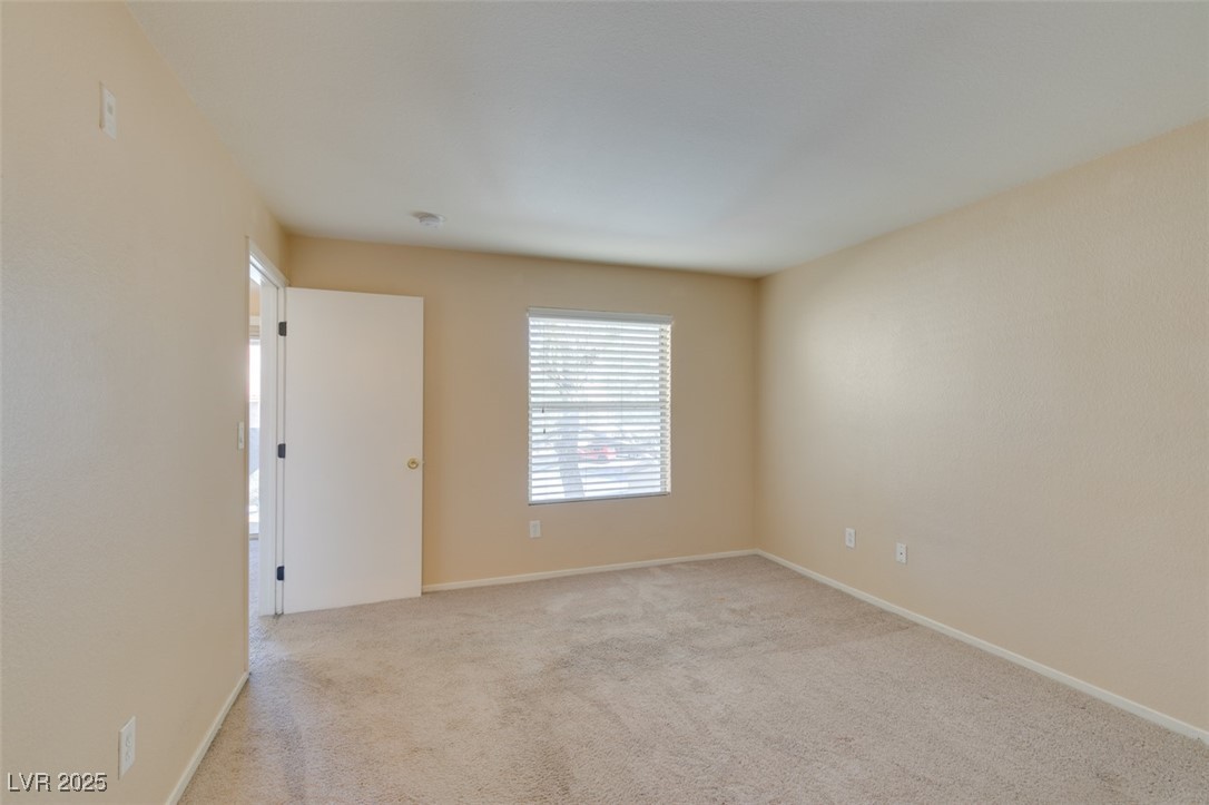 2300 East Silverado Ranch Boulevard, Unit 2190 Las Vegas, NV 89123 - Photo 36 of 41 Empty room featuring light colored carpet and baseboards