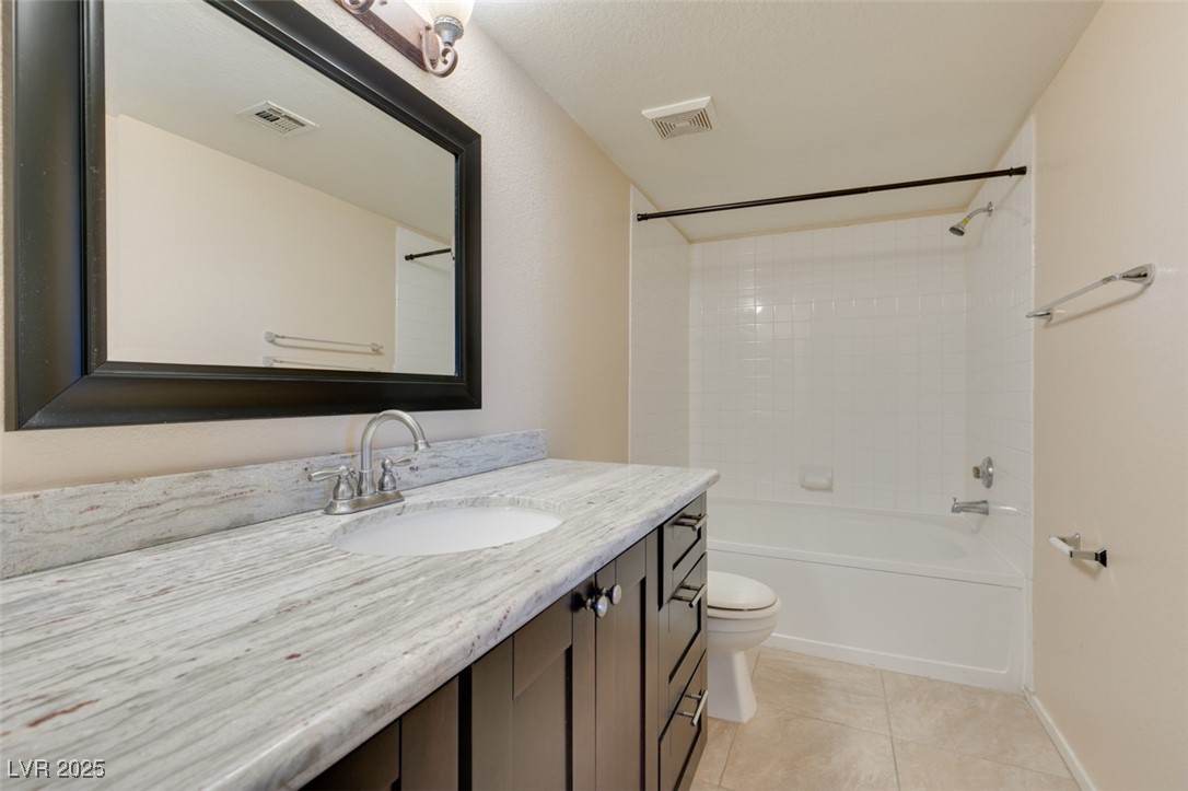 2300 East Silverado Ranch Boulevard, Unit 2190 Las Vegas, NV 89123 - Photo 9 of 41 Bathroom with shower / bathtub combination, vanity, and light tile patterned flooring