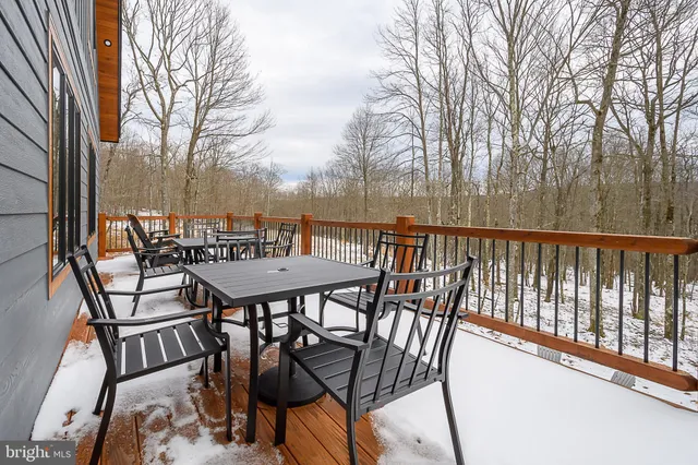 a view of a chairs and table on the deck