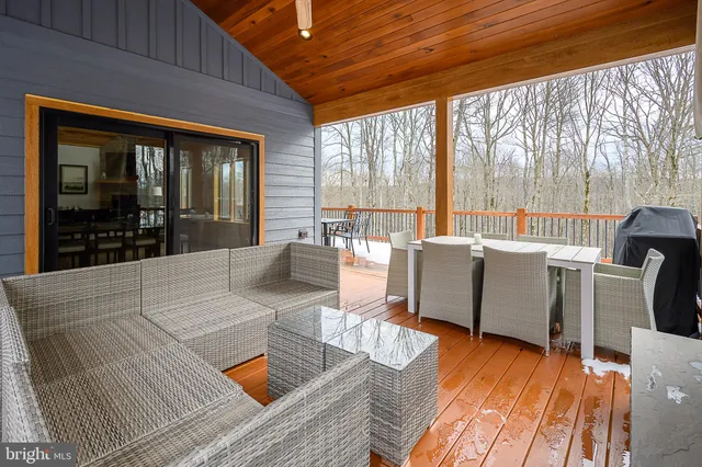a balcony with chairs and wooden floor