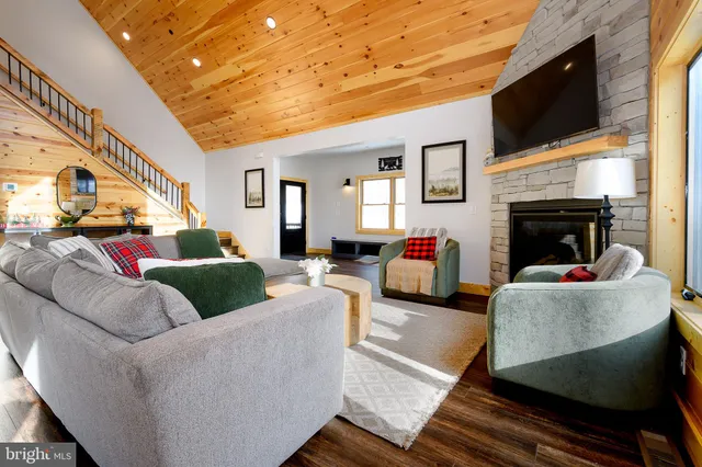 a living room with furniture and a chandelier
