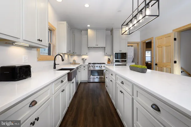 a stove top oven sitting inside of a kitchen