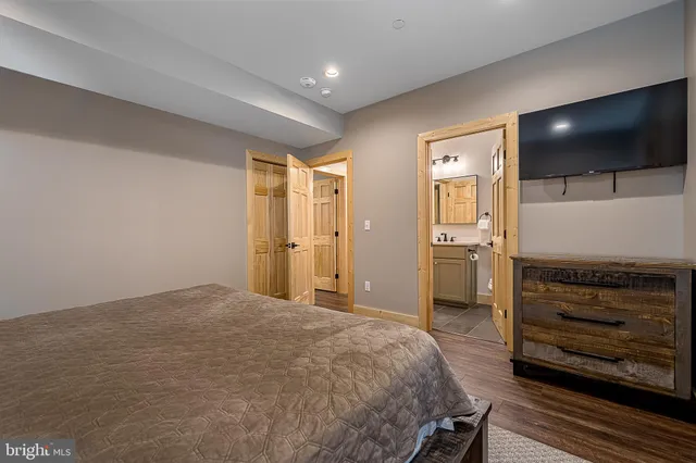 a bedroom with a bed and a night stand