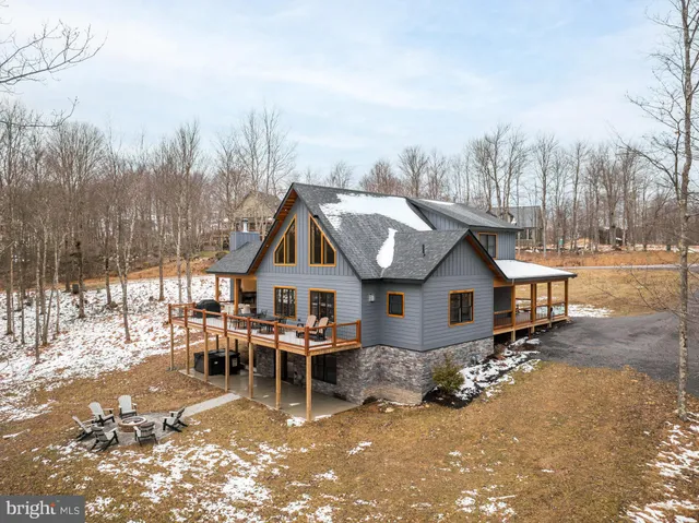 an aerial view of a house with a big yard and large trees