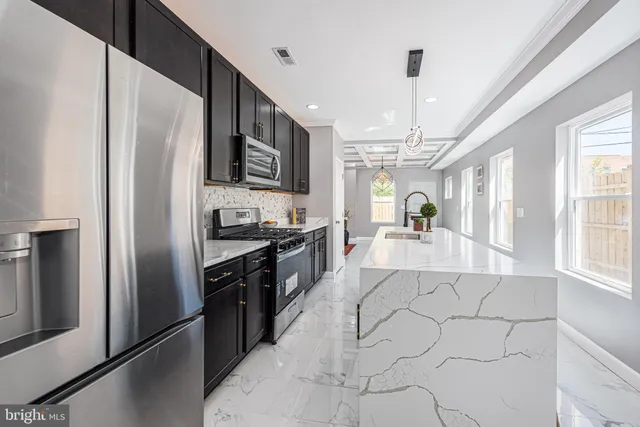 a large kitchen with cabinets and stainless steel appliances