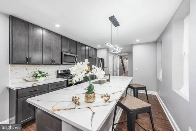 a view of a dining room with furniture a chandelier and wooden floor