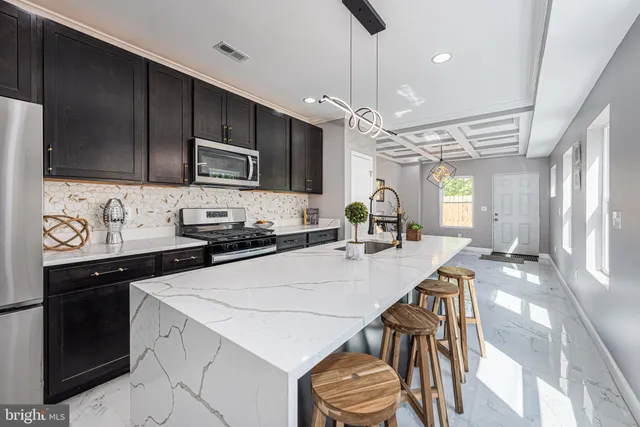a kitchen with a table chairs microwave and cabinets