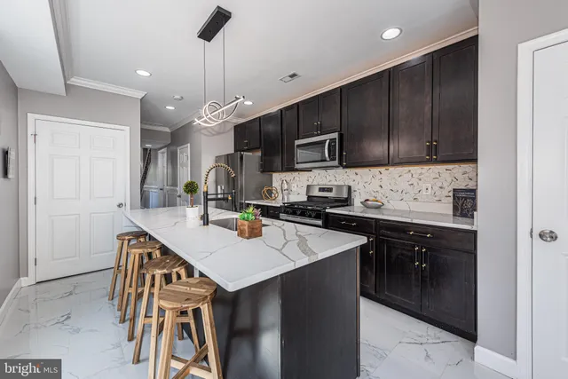 a kitchen with a sink a microwave and cabinets