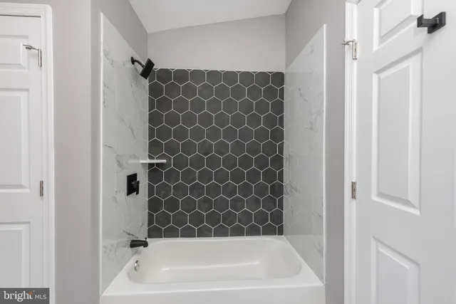 a bathroom with a bathtub and shower