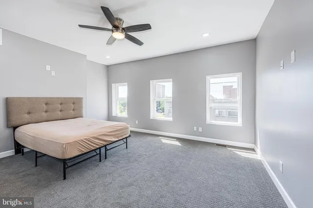 a spacious bedroom with a bed and window