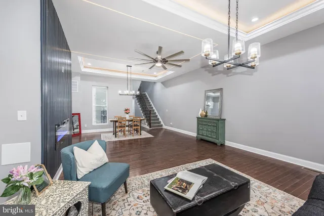 a living room with furniture and a chandelier