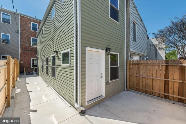 a view of a house with a wooden fence