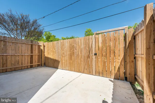 a view of a backyard with wooden fence