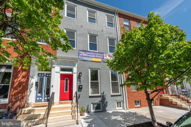 front view of a house with a tree