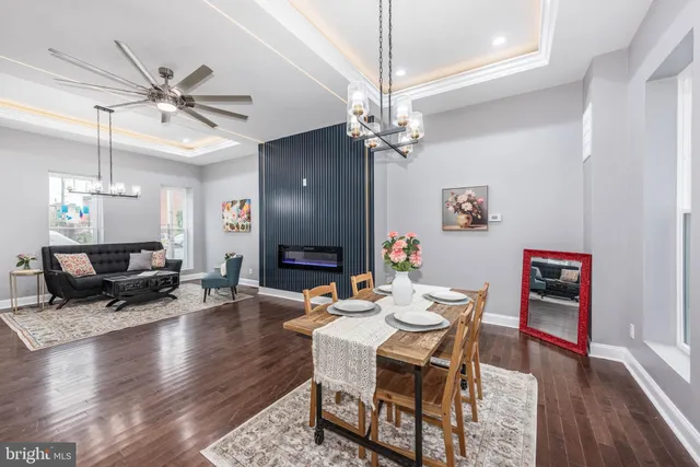 a view of a dining room with furniture wooden floor and chandelier