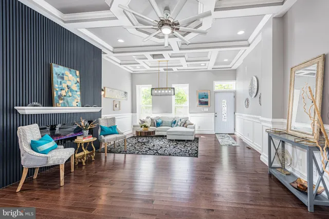a living room with furniture wooden floor and a chandelier