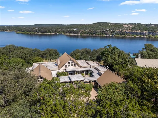 an aerial view of a house with a lake view