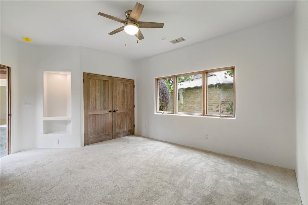 24736 Travis Lakeside Cove, Unit A Spicewood, TX 78669 - Photo 11 of 36 a view of an empty room with a window