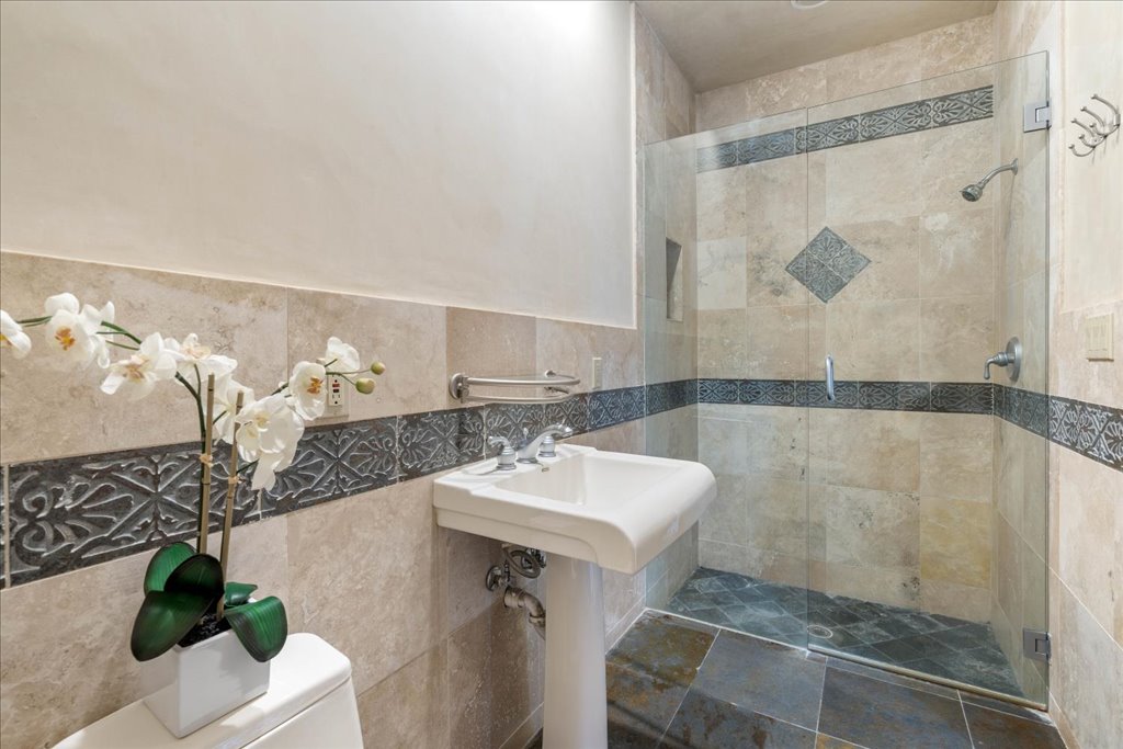 24736 Travis Lakeside Cove, Unit A Spicewood, TX 78669 - Photo 12 of 36 a bathroom with a sink mirror and vanity