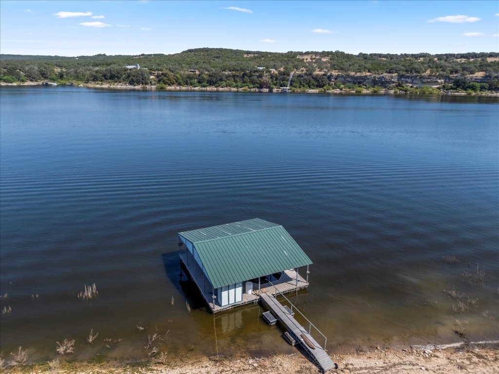 24736 Travis Lakeside Cove, Unit A Spicewood, TX 78669 - Photo 25 of 36 a view of a lake with a mountain