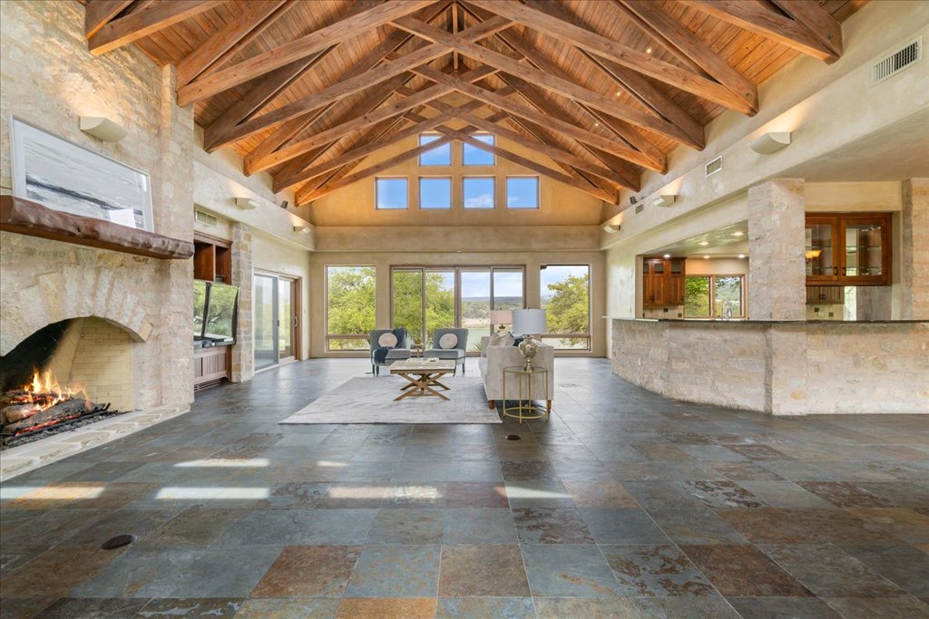 24736 Travis Lakeside Cove, Unit A Spicewood, TX 78669 - Photo 3 of 36 a view of a living room a livingroom with furniture and a fireplace