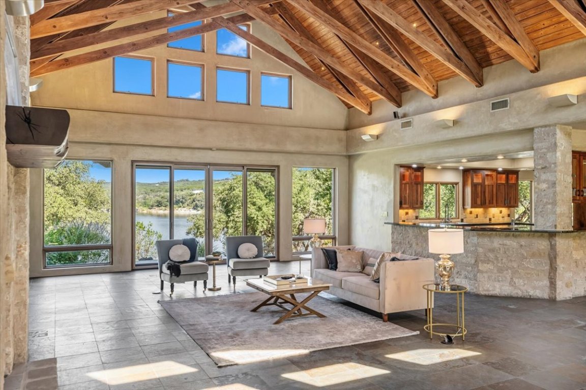 24736 Travis Lakeside Cove, Unit A Spicewood, TX 78669 - Photo 35 of 36 a living room with furniture and a large window