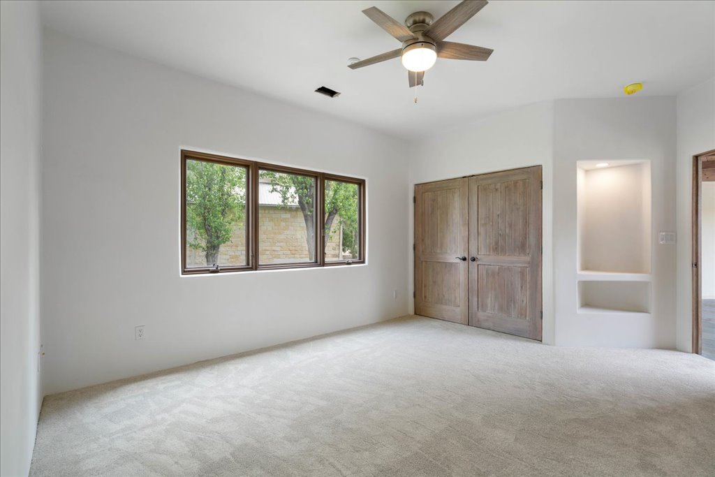 24736 Travis Lakeside Cove, Unit A Spicewood, TX 78669 - Photo 8 of 36 a view of an empty room with a window