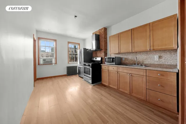 a kitchen with stainless steel appliances granite countertop a stove a sink and a refrigerator