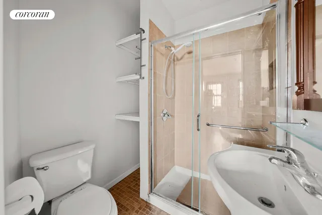 a bathroom with a sink toilet and shower