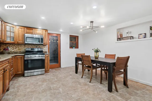 a view of a dining room with furniture and a kitchen