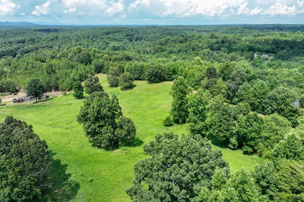 4854 Cagle Mill Road Lula, GA 30554 - Photo 15 of 20 a view of a garden with a building in the background