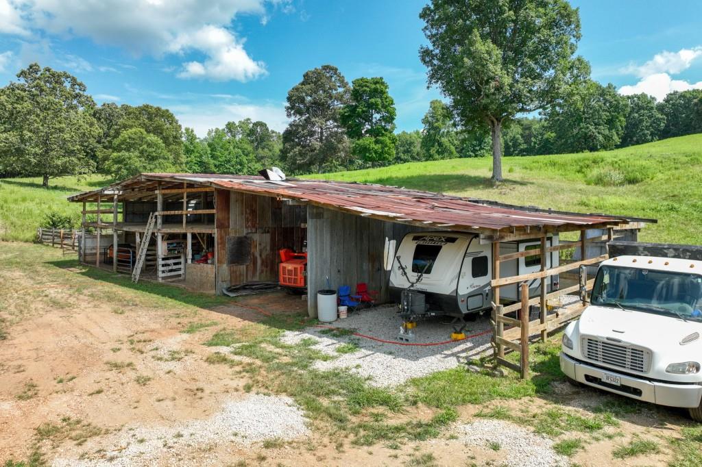 4854 Cagle Mill Road Lula, GA 30554 - Photo 10 of 20 a view of a house with a backyard and a patio