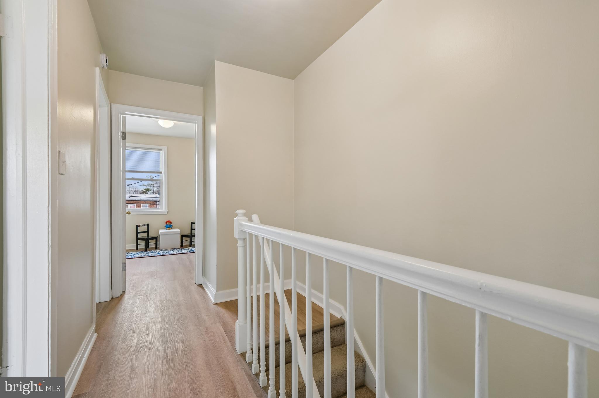 705 Tolna Street Baltimore, MD 21224 - Photo 15 of 34 a view of a hallway with wooden floor and a bathroom