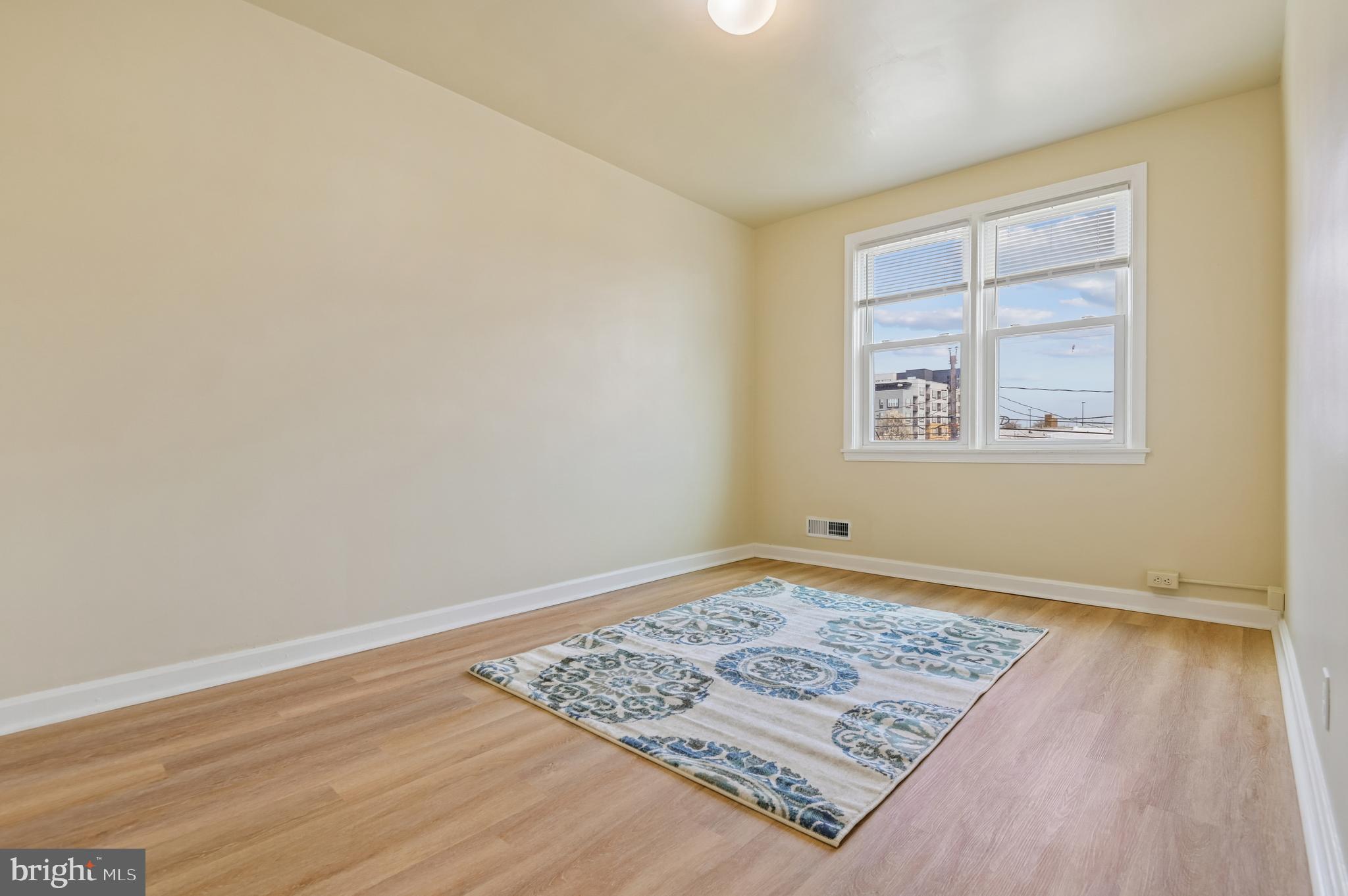 705 Tolna Street Baltimore, MD 21224 - Photo 20 of 34 an empty room with wooden floor and window